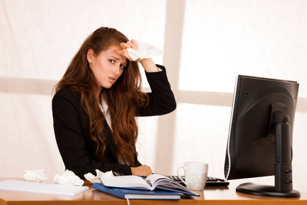 istock il woman suffering at work behind the desk in her office 1145083069