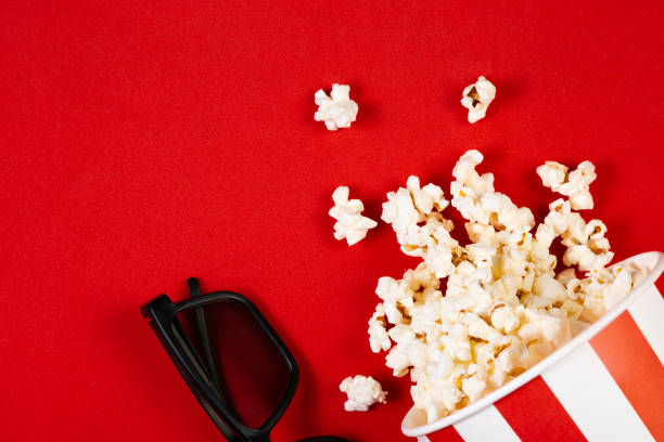 istock Movie night concept - pop corn, glasses, bright red background 1145084745
