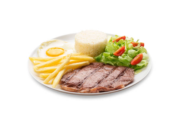 istock Steak, fried batafa, rice and salad on white background 1145085127