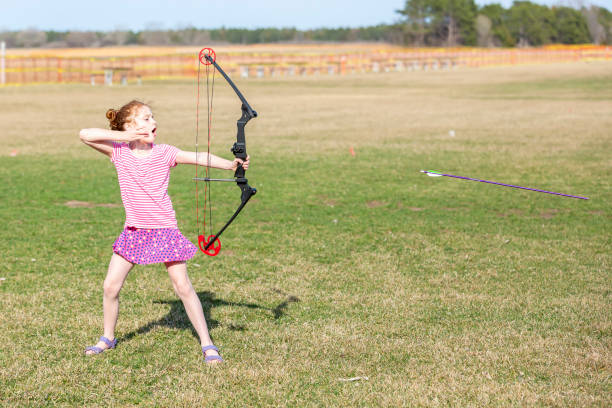 istock Young Girl With Bow & Arrow Practicing Archery 1145085728