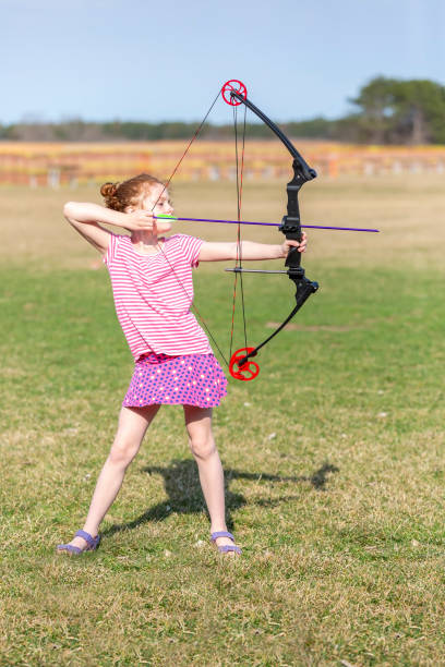 istock Young Girl Practicing Archery with Bow & Arrow 1145085731