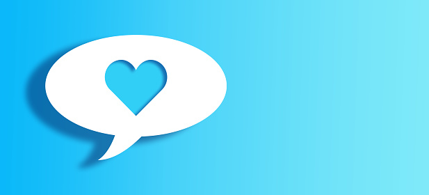 White Chat Bubble With Cut Out heart Shape Over Blue gradient Background with large copy space.