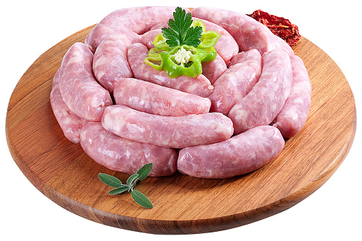 Pork, pork sausages, seasonings, wooden planks, peppers, tomatoes, pork, raw pork pieces. Raw meat. Swine steak, pork loin, swine shank and tongues.