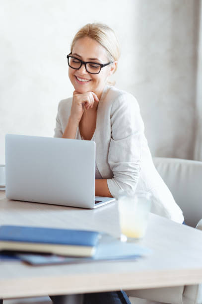 istock Happy woman working on a laptop 1145089615