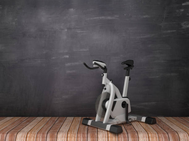 istock Exercise Bike on Wood Floor - Chalkboard Background - 3D Rendering 1145089773