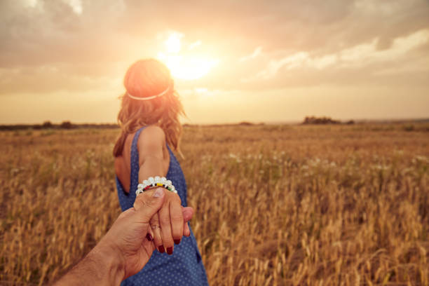 Young couple enjoying in a wheat field.