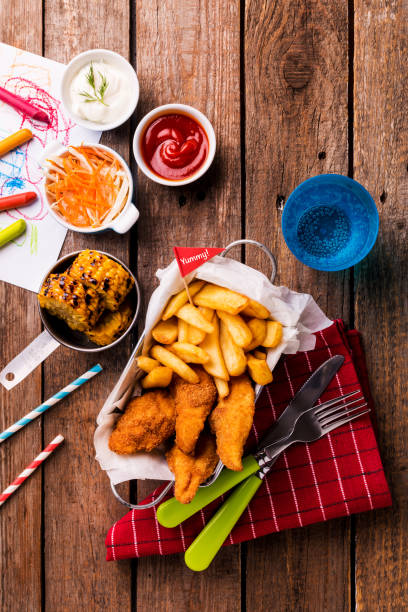 istock Kid's meal - chicken strips, fries, roasted corn and salad 1145091913
