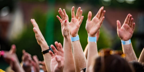 istock Concert crowd with raised hands 1145094226