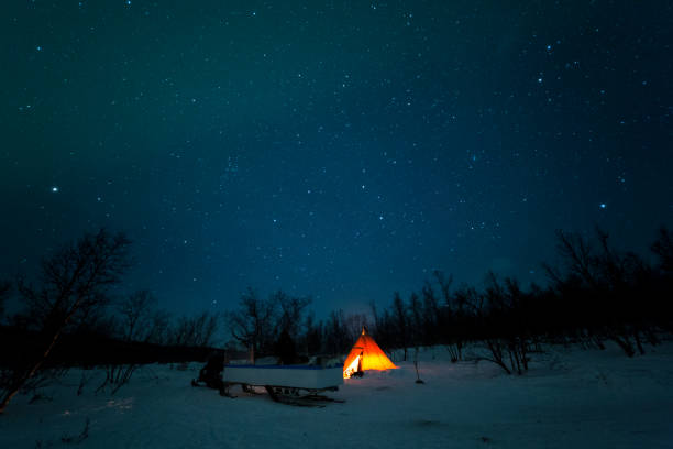 istock Epic orange lit tipi tent with northern lights and star sky 1145094559