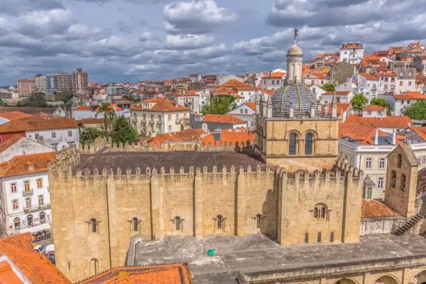 Coimbra / Portugal - 04 04 2019 : Aerial view of the medieval building of Coimbra Cathedral, Coimbra city and sky as background, Portugal