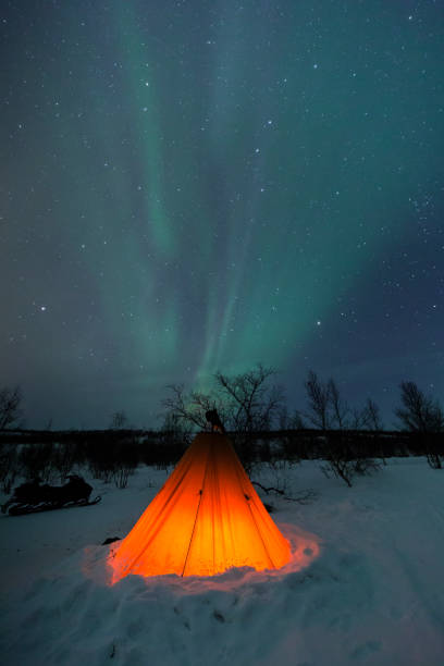 istock Epic orange lit tipi tent with northern lights and star sky 1145094670