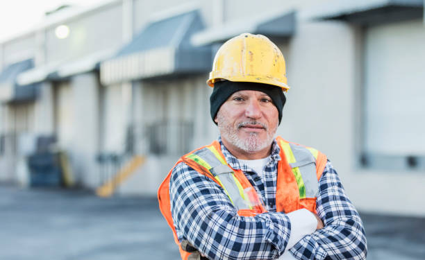 istock Hispanic worker outside with hardhat and safety vest 1145095003
