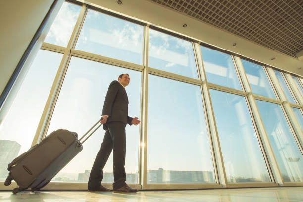 istock The businessman walk with a suitcase near panoramic windows 1145096081
