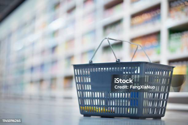 Shopping Basket On Floor In Supermarket Aisle Stock Photo - Download Image Now - Supermarket, Empty, Shopping Cart