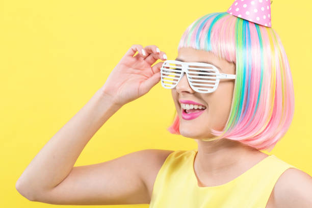 istock Woman in a wig with a party hat 1145097819