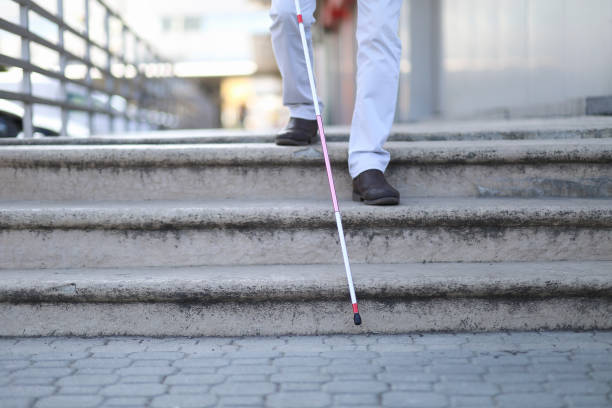 istock Blind and bearded man with a walking stick on the street 1145099143