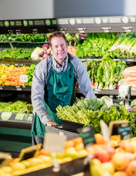 istock Man working in supermarket produce aisle 1145099843