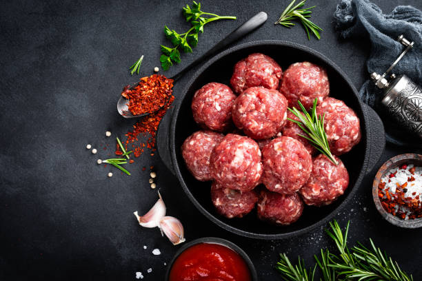 istock Fresh raw beef meatballs with spices and tomato sauce 1145101690