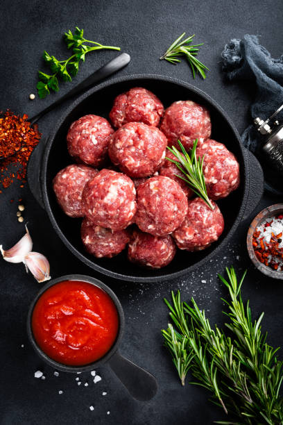 istock Fresh raw beef meatballs with spices and tomato sauce 1145101779