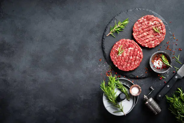 Fresh raw minced beef steak burgers with spices