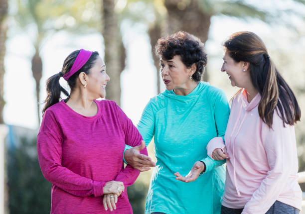 istock Three Hispanic women walking and talking in park 1145106332