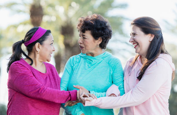 istock Three Hispanic women walking and talking in park 1145106380