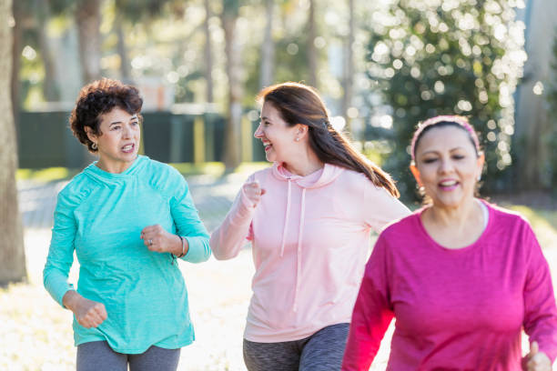 istock Three Hispanic woman in park, power walking 1145106520