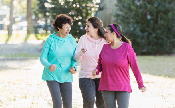 istock Three Hispanic woman in park, power walking 1145106574