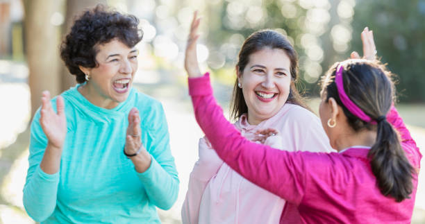 istock Three Hispanic woman in park, laughing together 1145106593