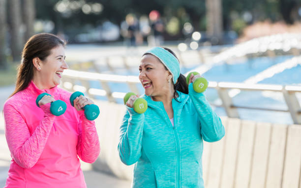 istock Two mature Hispanic women exercising with handweights 1145106646