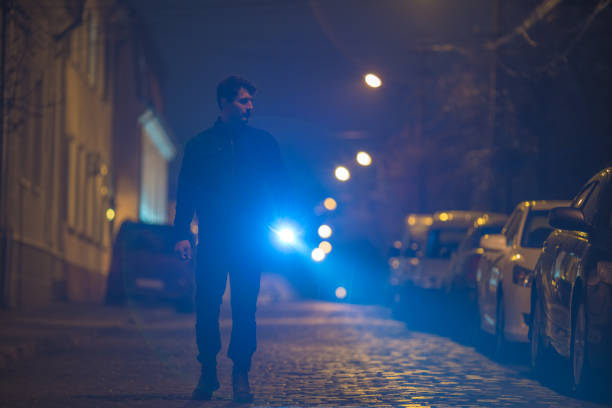istock The man with a flashlight inspect the street. Evening night time 1145106743