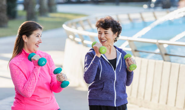 istock Two Hispanic women exercising with handweights 1145106752