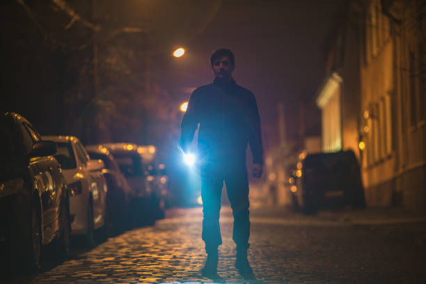 istock The man with a flashlight inspect the street. Evening night time 1145106765