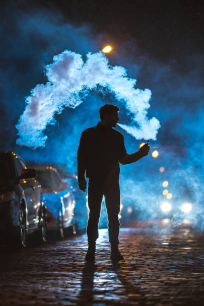 istock The man smoke electronic cigarette outdoor. Evening night time 1145106768