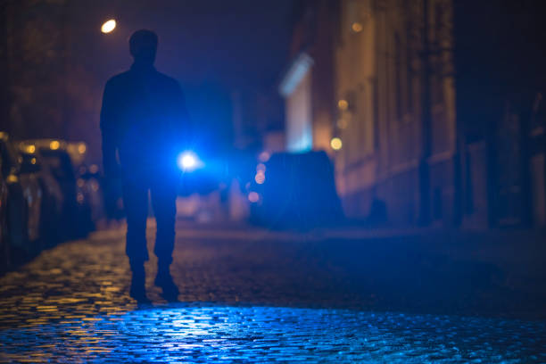 istock The man with a flashlight inspect the road. Evening night time 1145106815