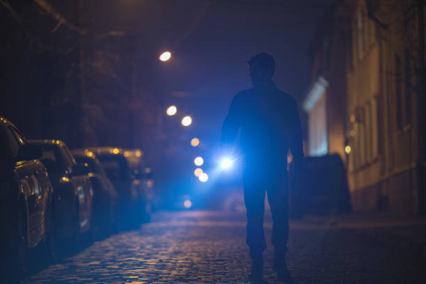 istock The man with a flashlight inspect the street. Evening night time 1145106878