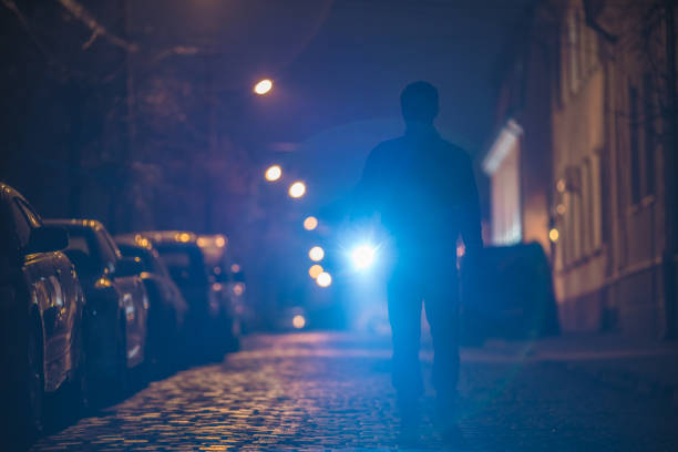 istock The man with a flashlight inspect the street. Evening night time 1145106887