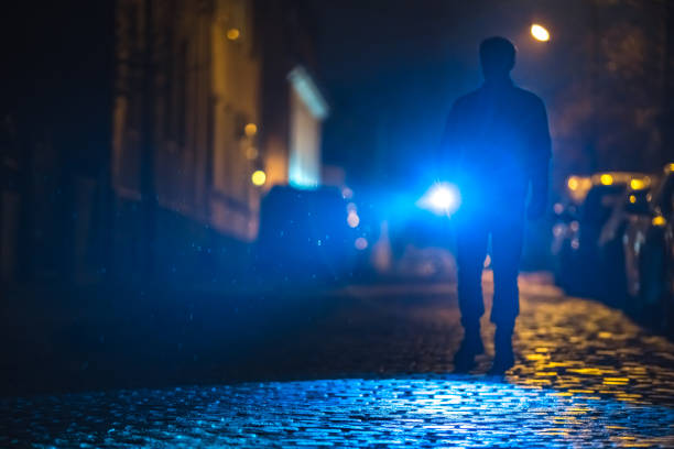 istock The man with a flashlight inspect the road. Evening night time 1145107437