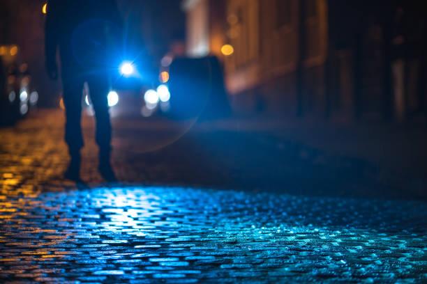 The man with a flashlight inspect the road. Evening night time