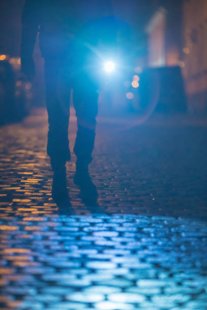istock The man with a flashlight stand on the road. Evening night time 1145107449