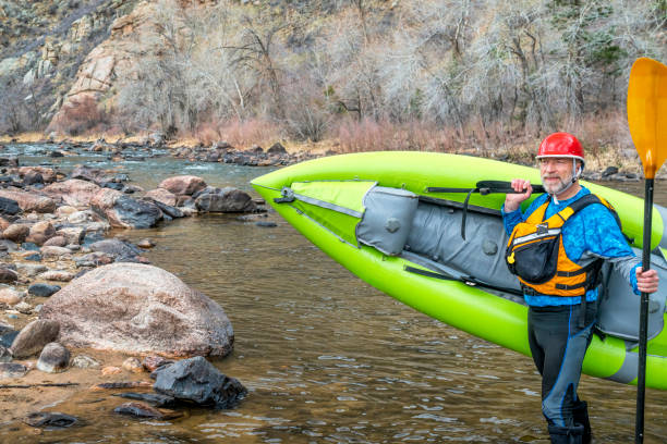 istock senior paddler carrying  inflatable whitewater kayak 1145108513