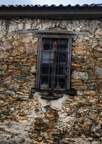 istock Window in an ancient wall of a Greek house 1145110073