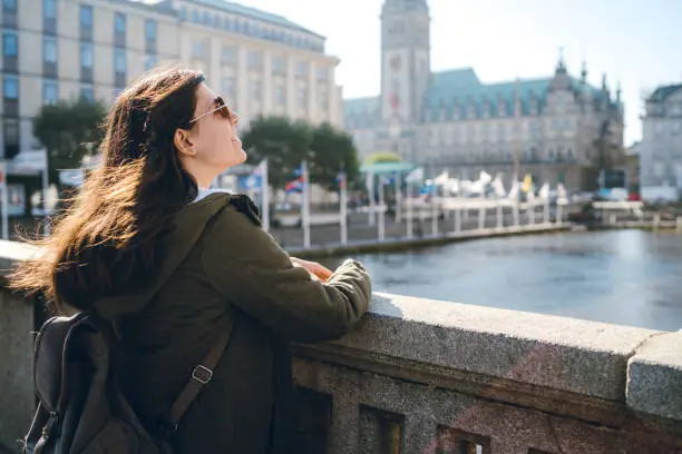 Young tourist woman is enjoying the view in Hamburg city center, Jungfernstieg