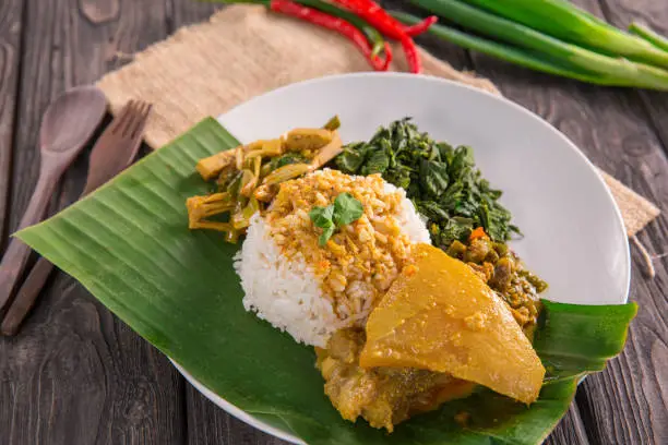 nasi padang served with beef tendon curry, young jackfruit and cassava leaves with sambal hijau or spicy sauce
