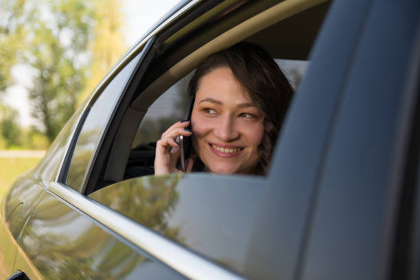 istock Gorgeous businesswoman using smart phone in the car 1145112154