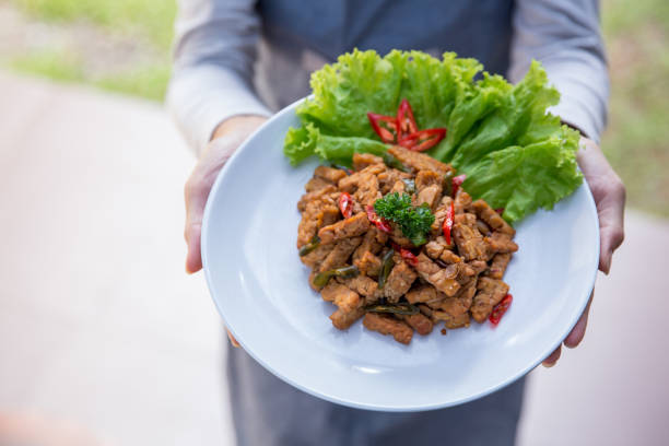 istock hand carrying indonesian food 1145112702