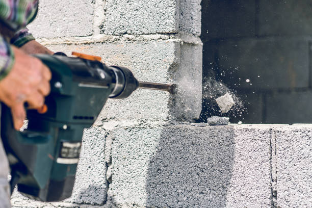 istock Construction industry worker using pneumatic hammer drill to cut the wall concrete brick, close up 1145113690