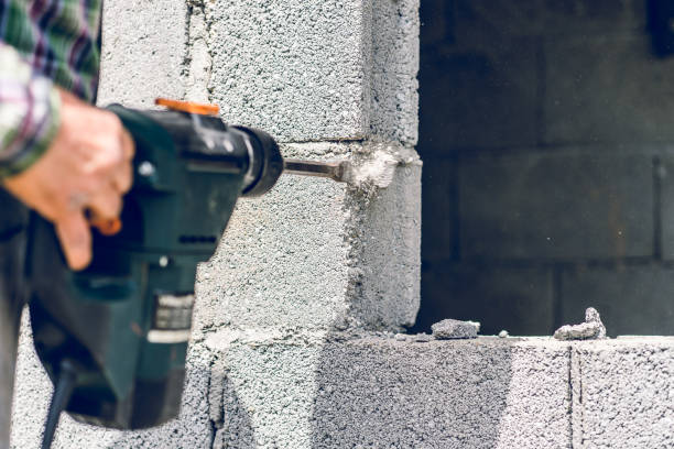 istock Construction industry worker using pneumatic hammer drill to cut the wall concrete brick, close up 1145113827