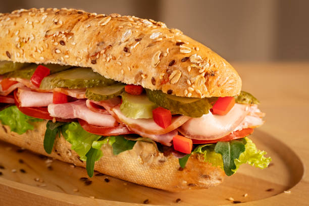 istock Sandwich with ham, pickles, fresh tomato and green salad 1145114635