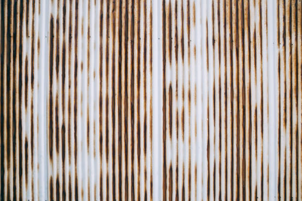 istock Old rusty wavy metal plate wall background 1145117131